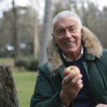 smiling old man with apple