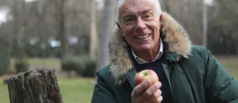 smiling old man with apple