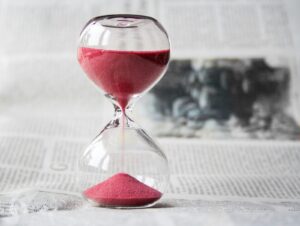 Image of an hourglass on a table.