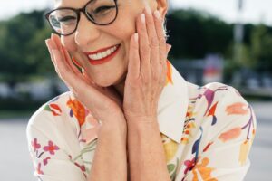 A smiling older woman looking young and happy.