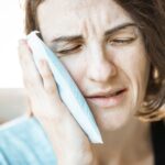 A woman experiencing jaw pain.